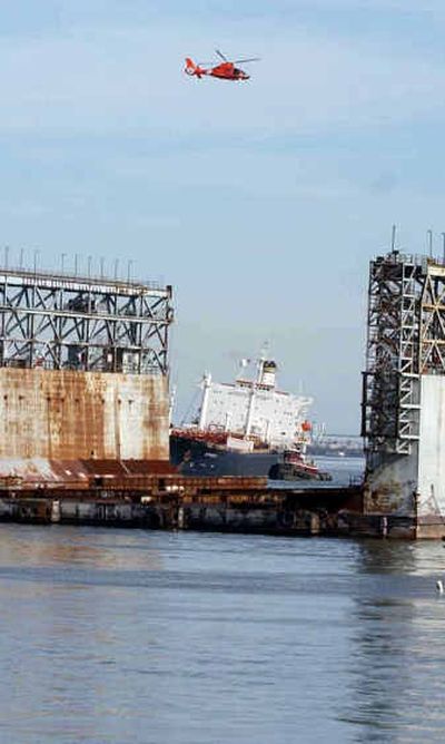 
A Coast Guard helicopter on Saturday flies over the listing Athos I tanker in the Delaware River near Paulsboro, N.J. 
 (Associated Press / The Spokesman-Review)