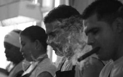
A man smokes a cigar as he rolls cigars at the Cohiba factory in Havana this week. 
 (Associated Press / The Spokesman-Review)