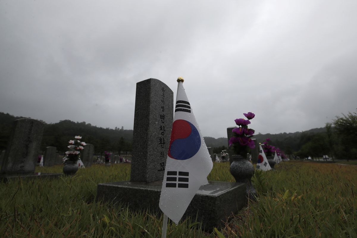 South Korean national flags are placed near the gravestones of soldiers who died during the 1950-1953 Korean War at the National Cemetery in Seoul, South Korea, Thursday, June 25, 2020. North and South Korea on Thursday marked the 70th anniversary of the start of the Korean War with largely subdued commemorations amid the coronavirus pandemic, a day after the North abruptly halted a pressure campaign against the South.  (Lee Jin-man)