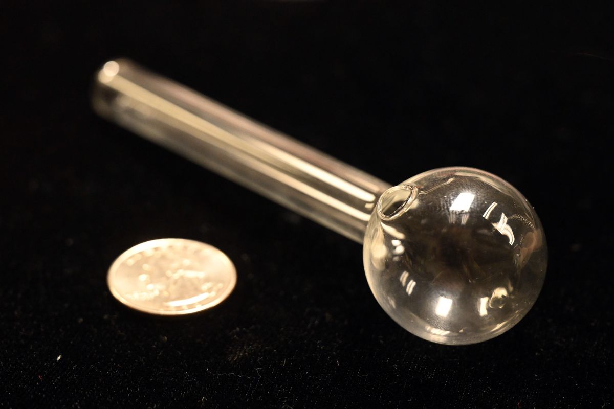 A simple glass pipe, commonly found at head shops and convenience stores, can be defined as “drug paraphernalia.” Shown next to a quarter coin for size comparison.  (Jesse Tinsley/THE SPOKESMAN-REVIEW)