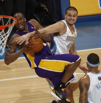 Lakers guard Kobe Bryant, left, is fouled by Nuggets forward Linas Kleiza.  (Associated Press / The Spokesman-Review)