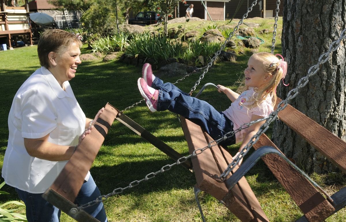 Deb Pittack gives a gentle push to her granddaughter on the family swing.  (Dan Pelle / The Spokesman-Review)