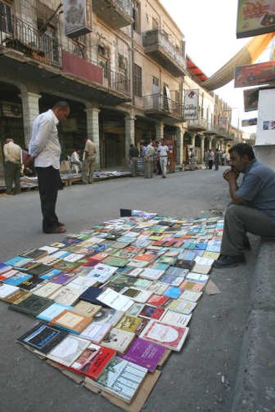
A man browses at the newly reopened Al-Mutmabi book market in Baghdad on Friday. The market was destroyed March 6 when a suicide car bomber killed at least 38 people. Associated Press
 (Associated Press / The Spokesman-Review)