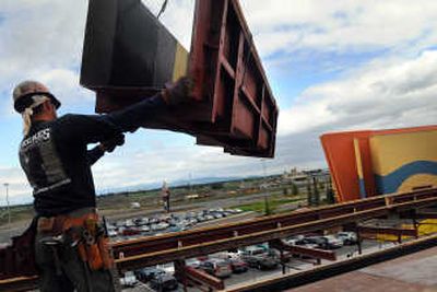 
Ruben Camas, of Garco Construction, maneuvers a beam for the new parking garage at Northern Quest Casino in Airway Heights on Wednesday.
 (Photos by RAJAH BOSE / The Spokesman-Review)