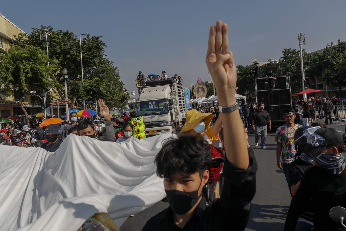 Students led pro-democracy protesters flash three-finger salute as they march to the Democracy Monument in Bangkok, Thailand, Saturday, Nov. 14, 2020.  (Sakchai Lalit)