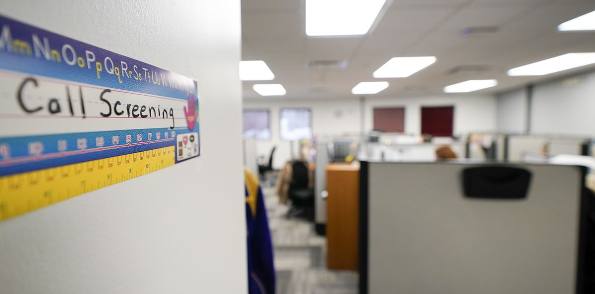 Workers field calls at an intake call screening center for the Allegheny County Children and Youth Services office in Penn Hills, Pa. on Thursday, Feb. 17, 2022. Incidents of potential neglect are reported to Allegheny County’s child protection hotline. The reports go through a screening process where the algorithm calculates the child’s potential risk and assigns it a score. Social workers then use their discretion to decide whether to investigate those concerns.  (Keith Srakocic)