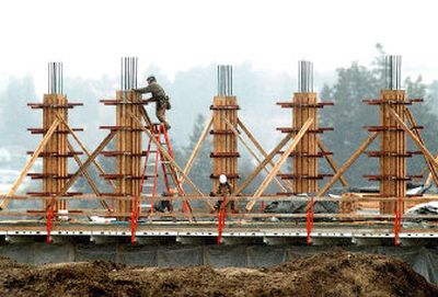 
Construction workers labor on the third floor of the new Schweitzer Engineering Laboratories headquarters building in Pullman on Monday. The five-story structure will have 90,000 square feet and will open in October.
 (Joe Barrentine / The Spokesman-Review)