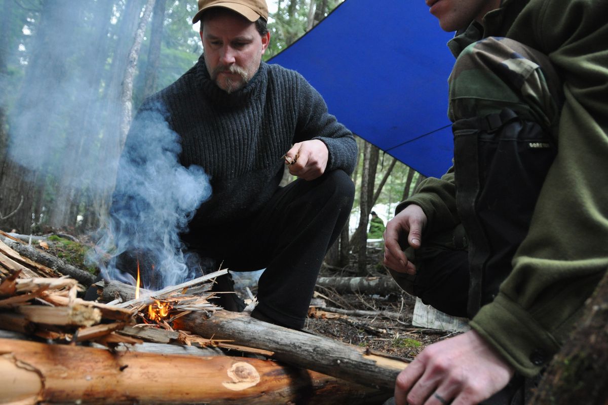 After a seminar on building a fire in wet conditions, Adam Dewey of Sandpoint applies the techniques to stoke a blaze on Feb. 1, 2010, during a misty morning search and rescue team exercise at Priest Lake State Park. The instructor for this group of students was Nick Weber of the Survival School at Fairchild Air Force Base.  The next photos follow Weber