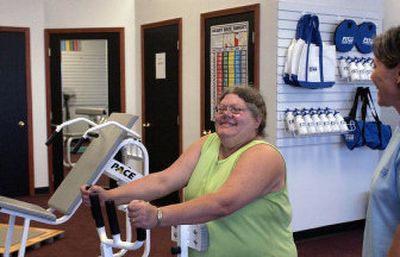 
Sherry Byrum works out her upper body on a lateral row machine at Fit over 40 in Spokane Valley. 
 (Liz Kishimoto / The Spokesman-Review)