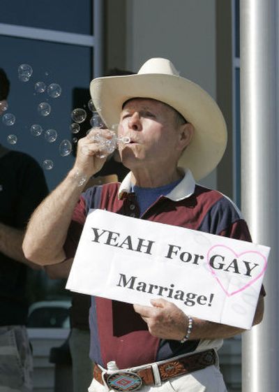
Joe Crews of Fallbrook, Calif., blows bubbles in front of the San Diego County Clerk's office in support of a same-sex couple exiting the building in San Marcos, Calif., on Tuesday. Crews said he'd be getting married Tuesday, too, if his longtime partner had not died last year. San Diego Union-Tribune
 (Charlie Neuman San Diego Union-Tribune / The Spokesman-Review)