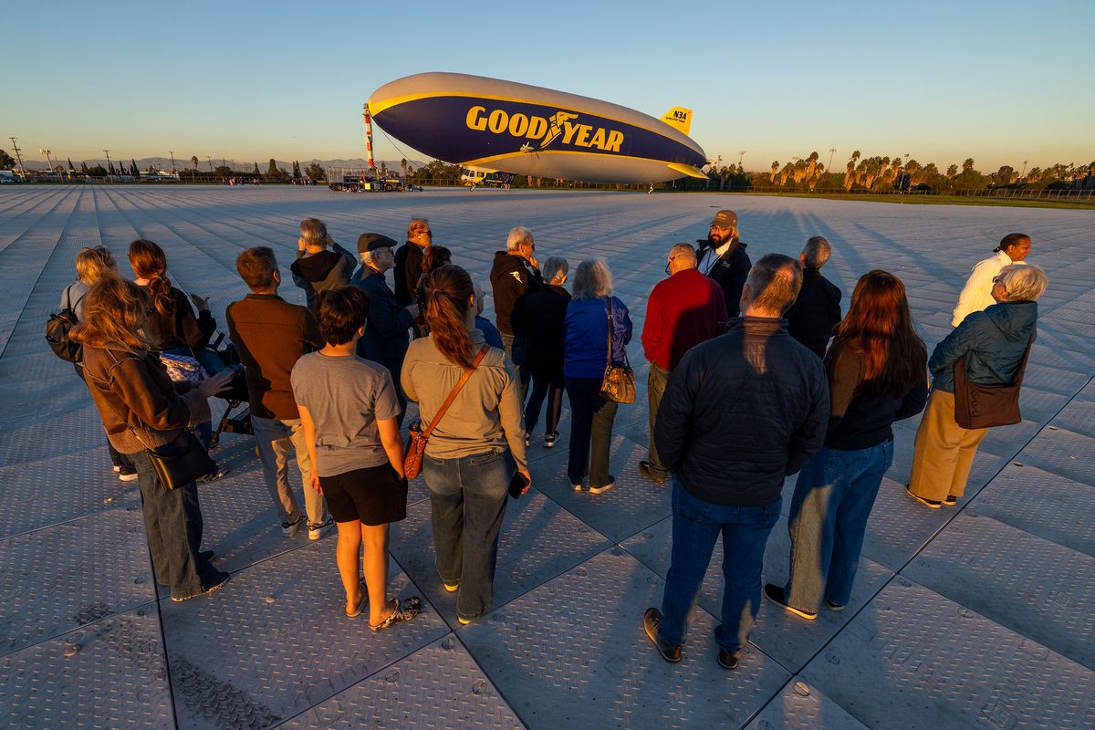 Attendees are taken on a guided tour of Goodyear Blimp Wingfoot Three during the Toys for Tots event at the Goodyear Blimp Base Airport on Friday, Dec. 5, 2025, in Carson, California.   (Ronaldo Bolanos/Los Angeles Times/TNS)