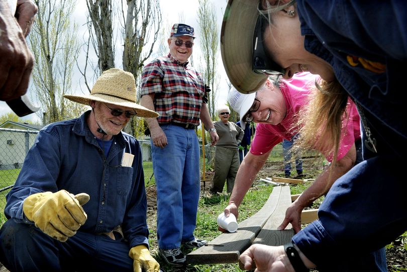 Members of Episcopal Church of the Resurrection from left, Alan Terry, Jerry Combs, Karen St. Clair and Jackie Woolf work together to build raised beds at the church on Sunday. (Kathy Plonka)