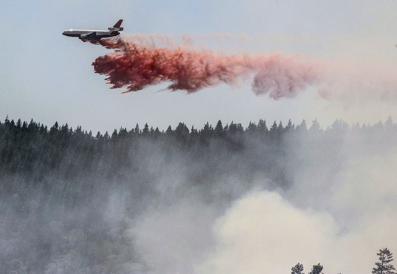 A plane drops fire retardant as firefighters battle a blaze in El Portal, Calif., near Yosemite National Park on Tuesday, July 29, 2014. Firefighters in the state are also battling another wildfire in the Sierra Nevada foothills east of Sacramento. (Al Golub / Fr149129 Ap)