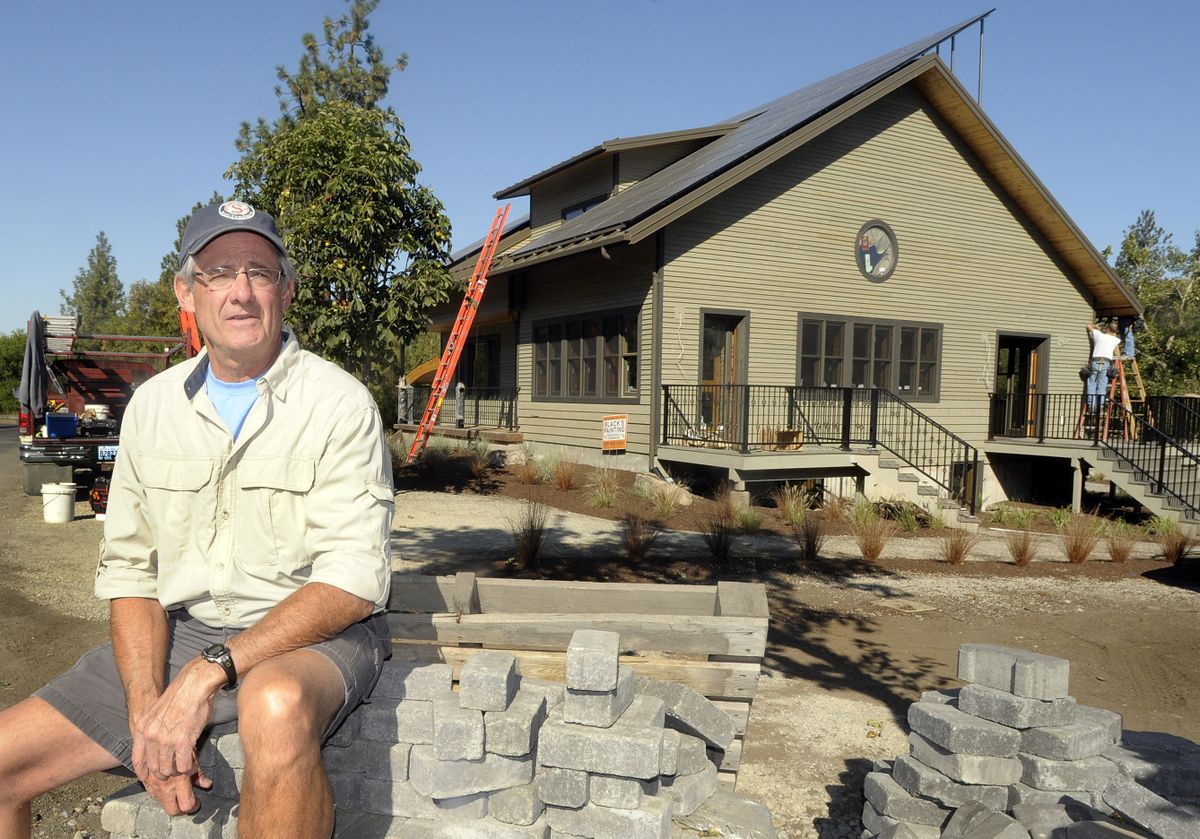 Jim Sheehan visits the site of his new home in the Peaceful Valley area on the Spokane River just west of downtown Spokane. The home has many energy conservation features, such as solar panels on the roof and in-floor heating.  (Photos by CHRISTOPHER ANDERSON / The Spokesman-Review)