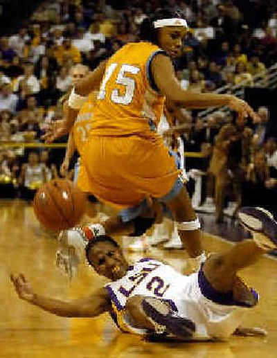 
LSU's Temeka Johnson, on floor, reaches for the ball behind Tennessee's Sa'de Wiley-Gatewood.
 (Associated Press / The Spokesman-Review)