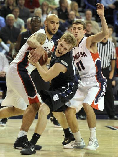 Gonzaga center Robert Sacre, left, strips the ball from Butler guard Jackson Aldridge as guard David Stockton (11) moves in during the second half of Tuesday night’s game in Spokane. (Colin Mulvany)