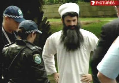 
This image taken from television shows Chas Licciardello, a member of an Australian TV comedy show dressed in a white tunic and wearing a long fake Osama bin Laden-style beard, being arrested by police in Sydney, Australia, Thursday. Associated Press
 (Associated Press / The Spokesman-Review)