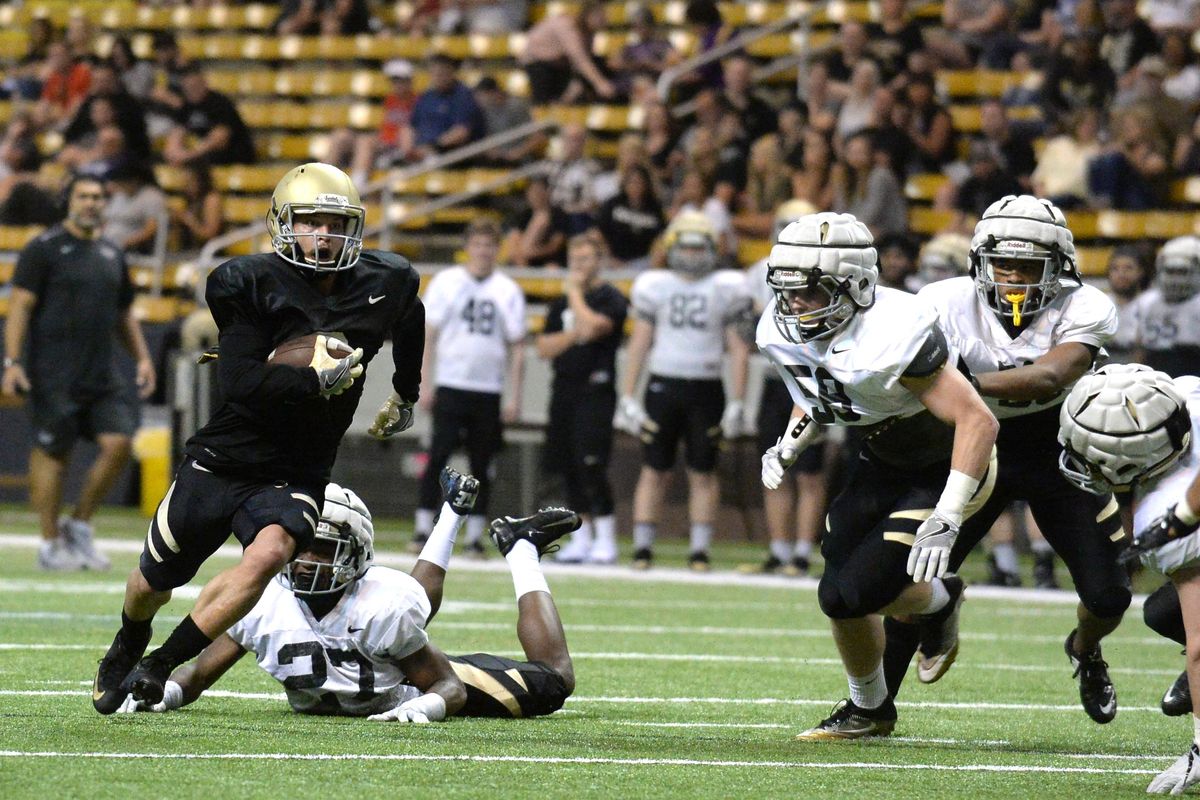 Senior wide receiver David Ungerer just slips past sophomore defensive back Tyrese Dedmon. (Cody Cottier / For The Spokesman-Review)