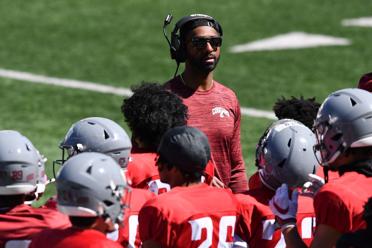 Washington State wide receivers coach Nick Edwards scopes out the Cougars’ second spring scrimmage Saturday in Pullman.  (Tyler Tjomsland/The Spokesman-Review)
