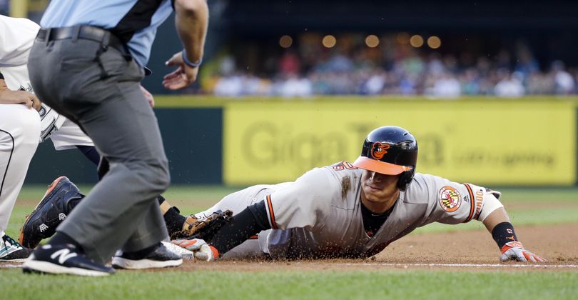 Baltimore’s Manny Machado is thrown out trying to stretch a single into a double on Thursday in Seattle. (Elaine Thompson / Associated Press)