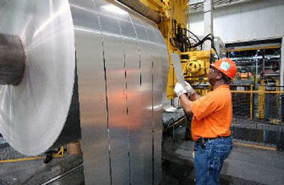 
Employee Fred Westbrook inspects finished rolls of aluminum as they come off the last stage of the production line at the Alcoa Warrick Operations in Newburgh, Ind. 
 (Associated Press / The Spokesman-Review)
