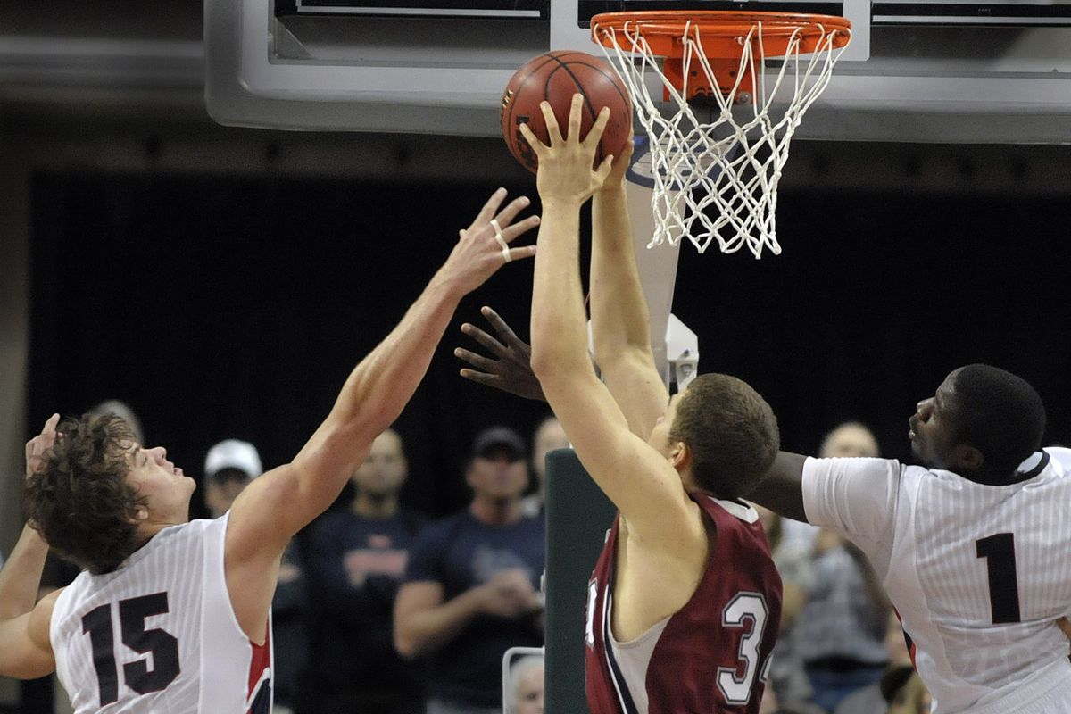 Matt Bouldin, left, and Mangisto Arop, right, battle with Drew Viney of Loyola for a rebound late in their semifinal game at the WCC tournament in the Orleans Arena in Las Vegas on Sunday, March 7, 2010. (Christopher Anderson / The Spokesman-Review)