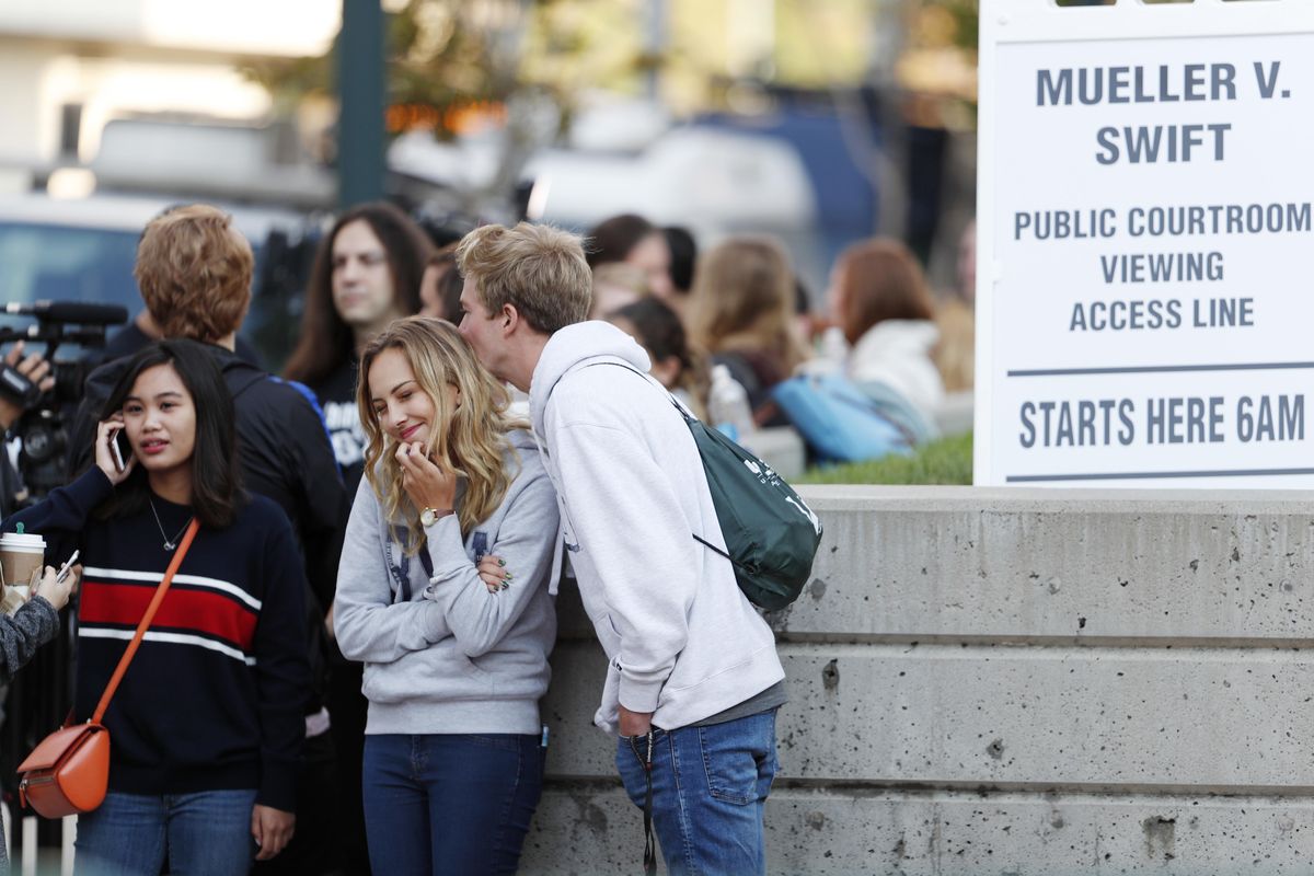 Ian Simpson, right, of Provo, Utah, kisses his wife, Lauren, as they wait at the head of the line for the public wait to get courtroom seats to view the third day of a civil trial to determine whether a radio host groped pop singer Taylor Swift in a case in federal court Wednesday, in Denver. former DJ David Mueller, who sued Swift after she said he touched her backside before a concert in Denver in 2013. He's seeking at least $3 million. Swift countersued for sexual assault and is seeking $1. ( (David Zalubowski / AP)