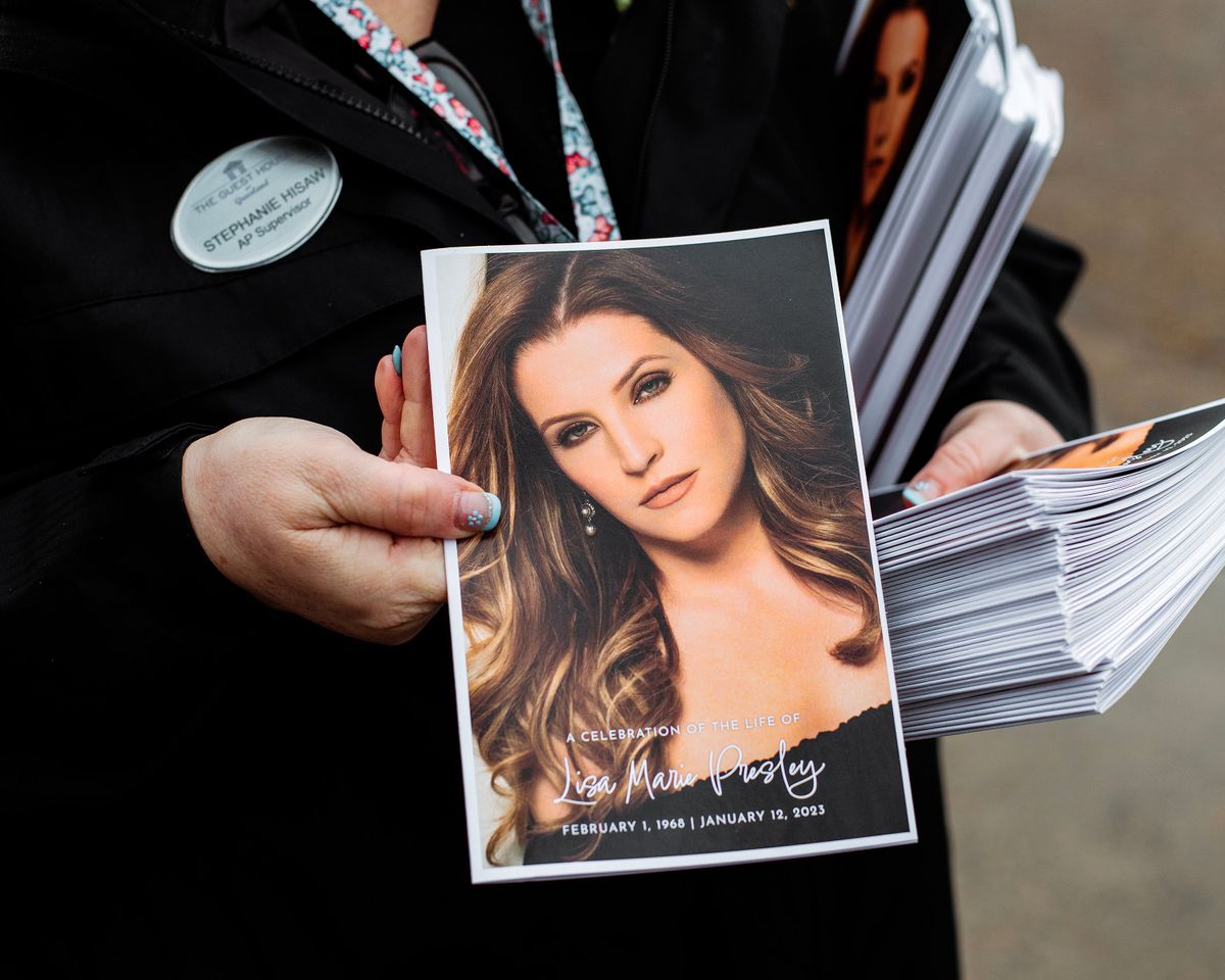 Programs are handed out at the memorial service for Lisa Marie Presley at Graceland in Memphis, Tenn., on Sunday, Jan. 22, 2023. Presley, the singer-songwriter and only child of Elvis Presley, died Jan. 12 in Los Angeles at age 54. (Houston Cofield/The New York Times)  (HOUSTON COFIELD)