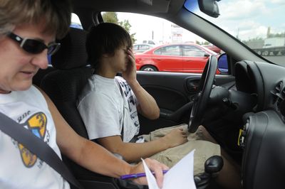 Jeremy Golding, 16, prepares himself mentally to take a driver’s education car on an hourlong freeway drive while driving instructor Jeanne Helfer fills out paperwork Wednesday. It was Golding’s ninth driving session with B&B Driving School in Spokane.jesset@spokesman.com (Jesse Tinsley / The Spokesman-Review)