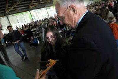 
Madeline Baker accepts an award from Post Falls Mayor Clay Larkin during the Mayor's Youth Awards at Q'emiln Park in Post Falls. 
 (Rajah Bose / The Spokesman-Review)