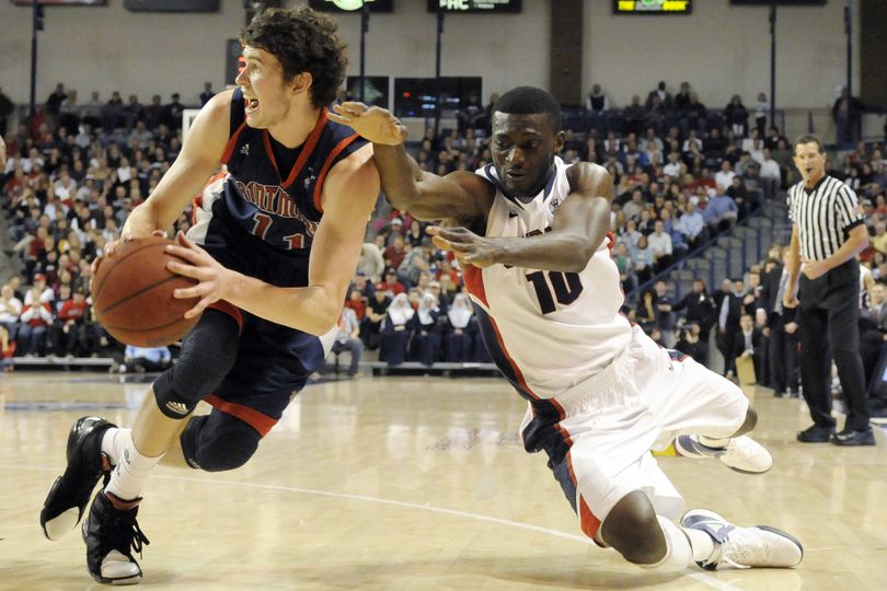 Saint Mary's Clint Steindl (11) passes as Gonzaga's Guy Landry Edi (10) defends during the first half of an NCAA college basketball game, Thursday, Feb. 9, 2012, in Spokane, Wash. (Jed Conklin / Fr170252 Ap)