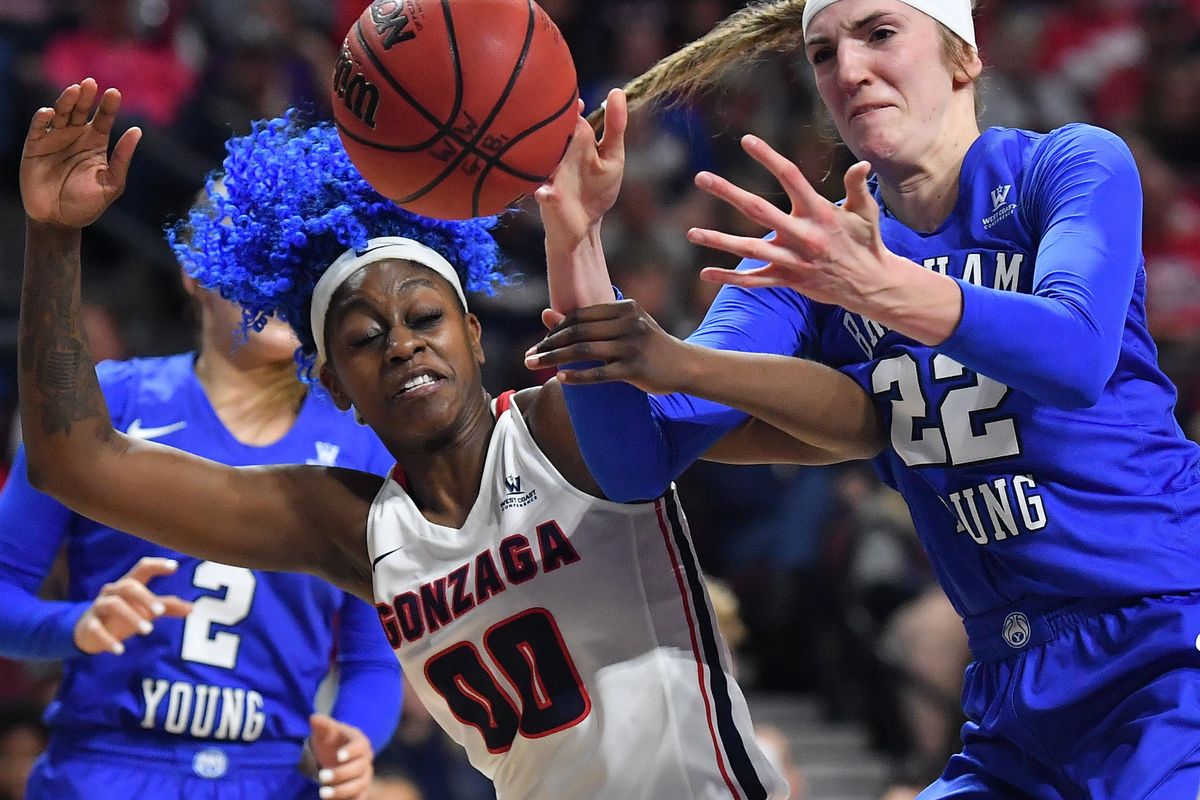 Gonzaga Bulldogs forward Zykera Rice (00) strains for a rebound against BYU Cougars center Sara Hamson (22) during the second half of a WCC women