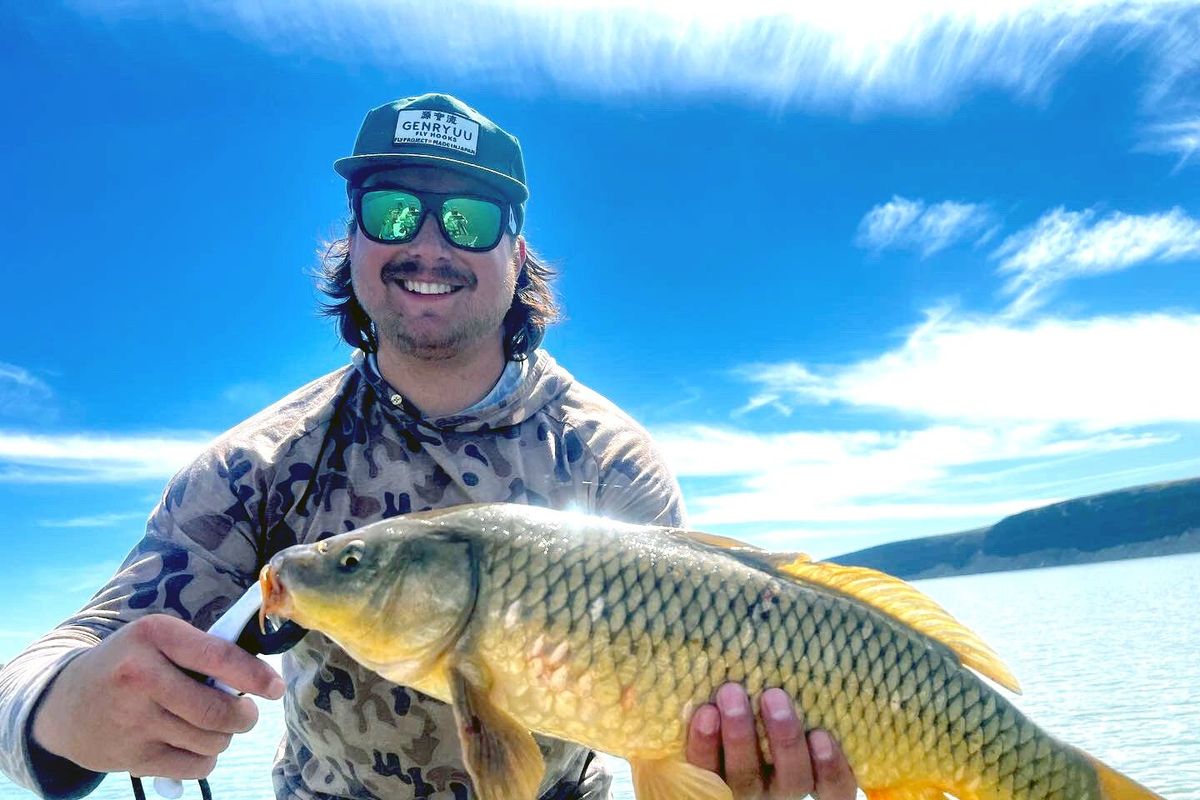 Drew Evans holds a carp he caught on a fly rod. He said fly fishing for carp is similar to fishing for salt water species like permit and tarpon only much closer to home.  (Courtesy photo)