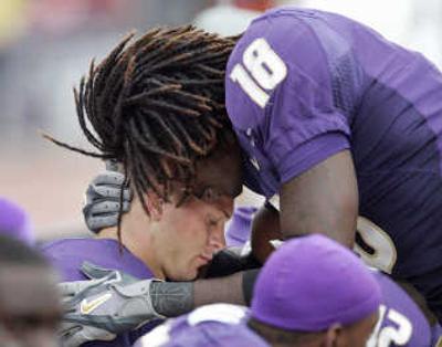 
Corey Williams (18) consoles QB Jake Locker late in game. Associated Press
 (Associated Press / The Spokesman-Review)