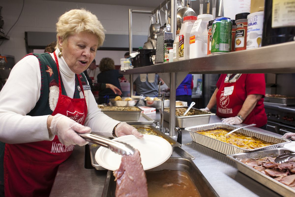 Darlene Packard scoops up slices of ham for the Salvation Army