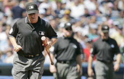 
Umpire Doug Eddings confiscates the bat of Tampa Bay's Akinori Iwamura. Associated Press
 (Associated Press / The Spokesman-Review)