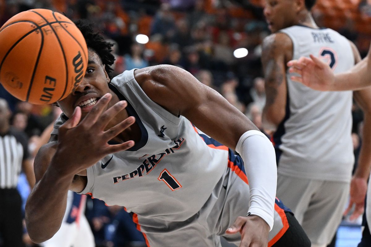 Pepperdine guard Michael Ajayi dives for a loose ball against Gonzaga in the first half of a college basketball game on January 18 at Firestone Fieldhouse in Malibu, Calif.  (TYLER TJOMSLAND/THE SPOKESMAN-REVIEW)