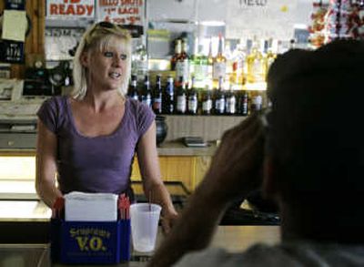 
Melissa Metz tends bar at the Corner Pub in Cincinnati. Metz draws most of her income as a bartender from customers' tips, which she says have been dwindling for months amid rising gas prices and other economic woes. Associated Press photos
 (Associated Press photos / The Spokesman-Review)