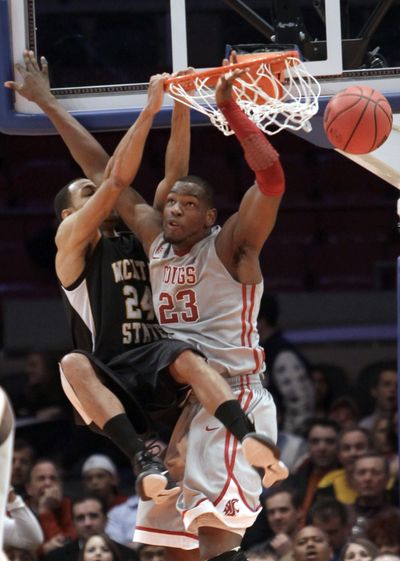 Wichita State’s David Kyles dunks the ball over Washington State’s DeAngelo Casto on Tuesday. (Associated Press)