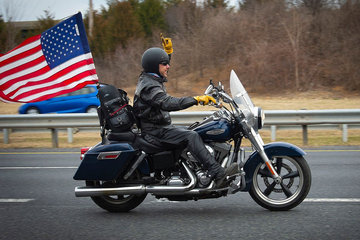 A supporter rides a motorcycle near the New Design Road bridge over I-270 in Frederick County as the “People’s Convoy” passed through the county as they made their way from Hagerstown to Washington, Sunday, March 6, 2022. (Bill Green)