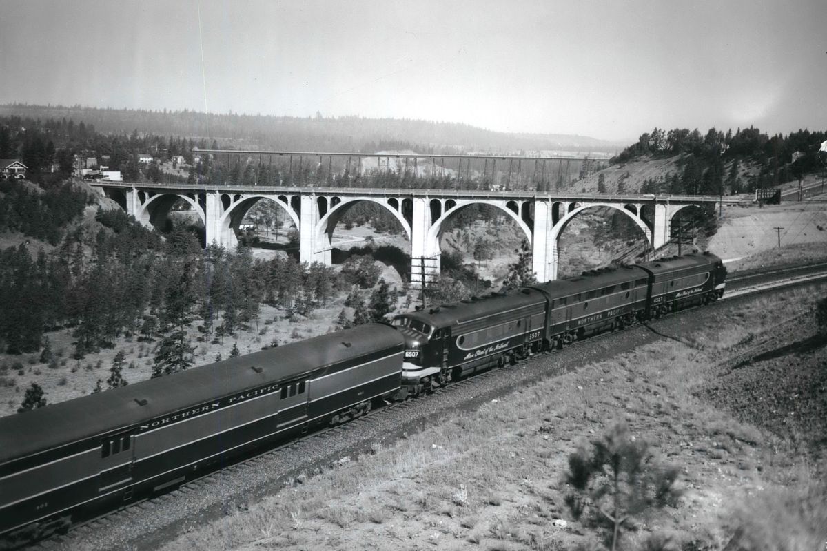 The Northern Pacific’s streamlined North Coast Limited enters Spokane from Portland along the rim of Hangman Canyon in 1953, passing near the concrete Sunset Highway Bridge. The steel bridge in the distance carried Union Pacific trains bound for Seattle. It was dismantled in the early 1970s after rail companies agreed to put all trains through a single downtown corridor in preparation for Expo ’74. (The Spokesman-Review photo archive)