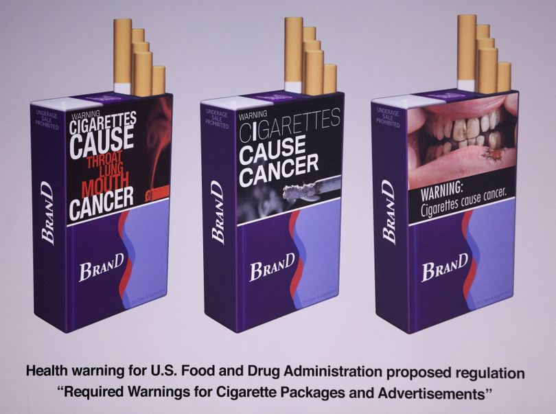 Three examples of proposed warnings for cigarette packaging as part of the government’s new tobacco prevention efforts are shown Wednesday  in Washington.  (Associated Press)