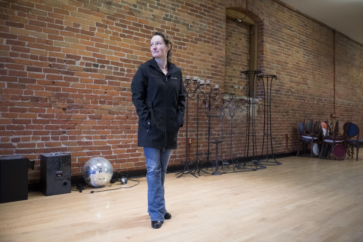 Amanda Hansen stands Thursday in front of a  wall in the 1910 building which her family owns at 433 W. Dean Avenue in Spokane. (Jesse Tinsley / The Spokesman-Review)
