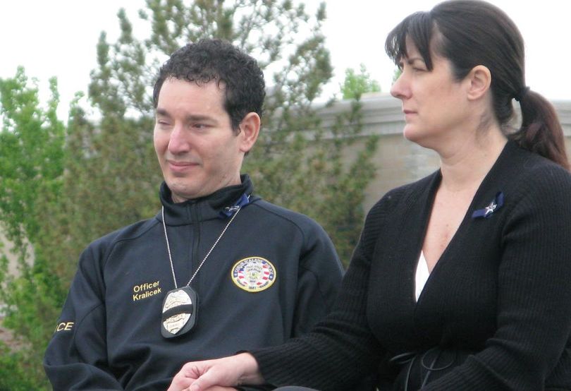 Mike and Carrie Kralicek listen as names of fallen Idaho officers are read at the state's Peace Officer Memorial Ceremony on Thursday; Mike Kralicek, who was shot while on duty as a Coeur d'Alene Police officer in 2004, was the keynote speaker. (Betsy Z. Russell)