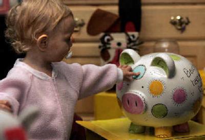 
Hanna Kennedy, 16 months, carefully touches a hand-painted ceramic pig made by Crayola during a direct sales Crayola party hosted by her mother Deelana Kennedy in Chambersburg, Pa.
 (The Spokesman-Review)