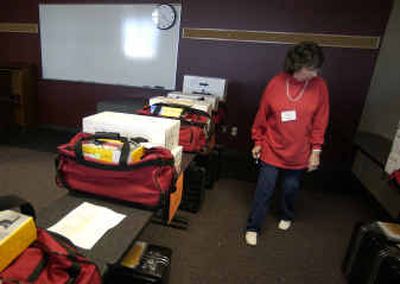 
Election inspector Jeanine Fritz looks for the polling booths for the Christ Lutheran Church precinct in the Spokane County elections office. 
 (Liz Kishimoto / The Spokesman-Review)
