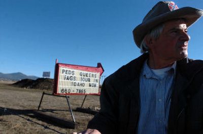 Jim Valentine stands near a sign he put up in Post Falls.
 (Jesse Tinsley / The Spokesman-Review)