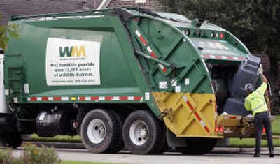 
Waste Management Inc. workers pick up trash Monday in Spring, Texas. Associated Press
 (Associated Press / The Spokesman-Review)