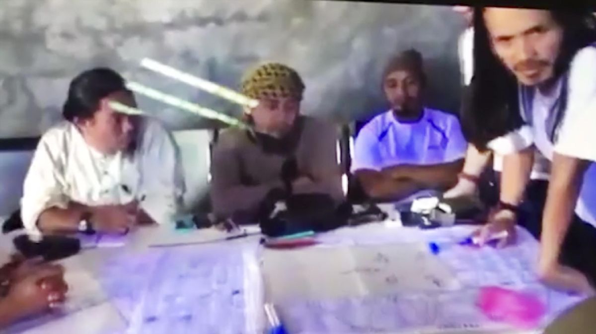 This image taken from undated video shown to the Associated Press by the Philippine military shows the purported leader of the Islamic State group Southeast Asia branch, Isnilon Hapilon, center, at a meeting of militants at an undisclosed location. The images offer a rare glimpse into the clandestine operations of insurgents who followed through two weeks ago with an unprecedented assault on the lakeside city of Marawi, parts of which they still occupy today. (Associated Press)