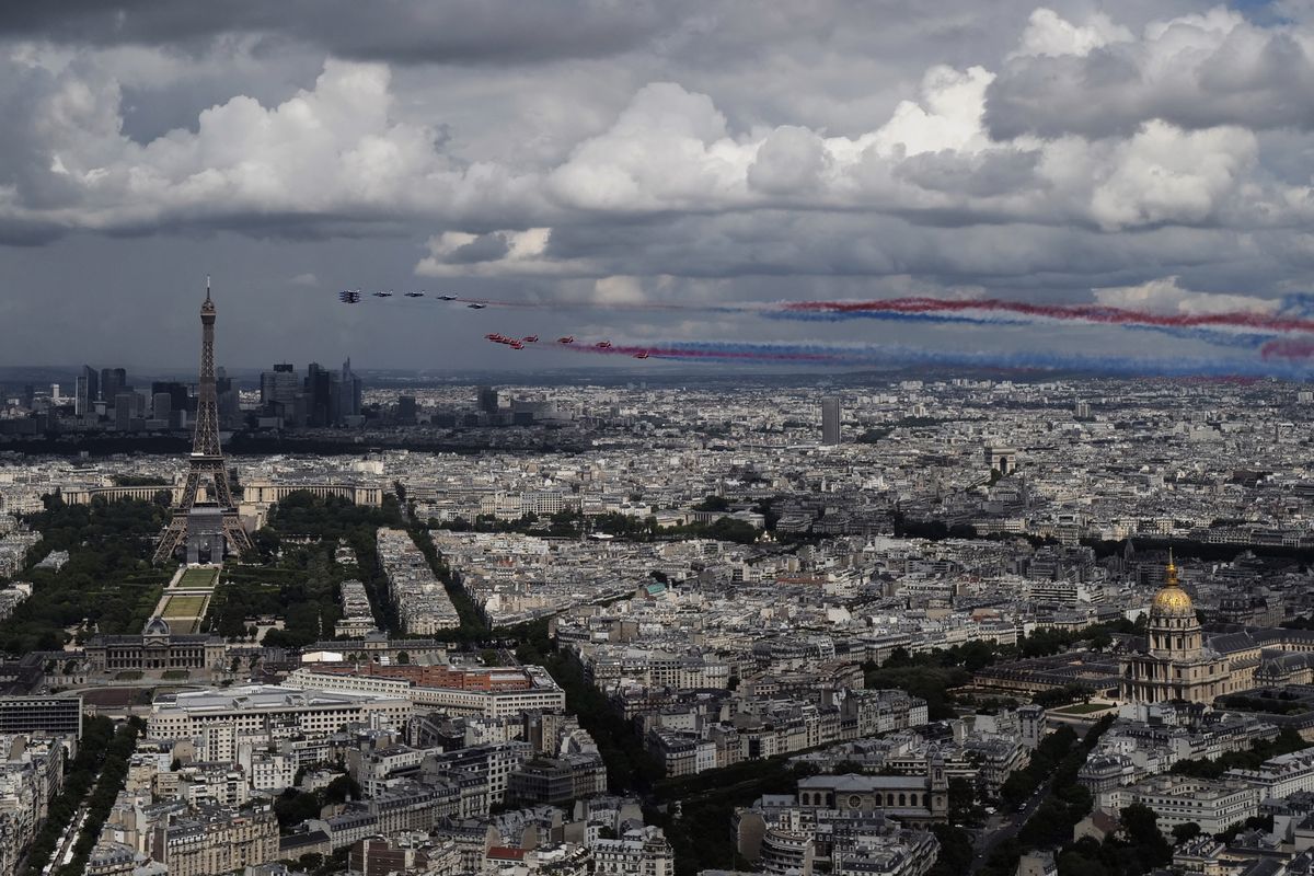 French Alpha jets of the Patrouille de France and the UK Royal red arrows aerobatic planes spraying lines of smoke in the colors of the French flag fly over the Eiffel Tower in Paris, Thursday, June 18, 2020 as part of commemoration for the 80th anniversary of Charles de Gaulle